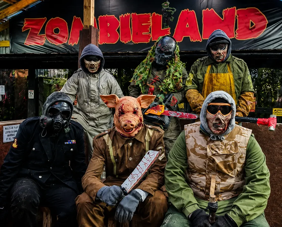 Zombie Uprising actors in masks in front of the Zombieland sign